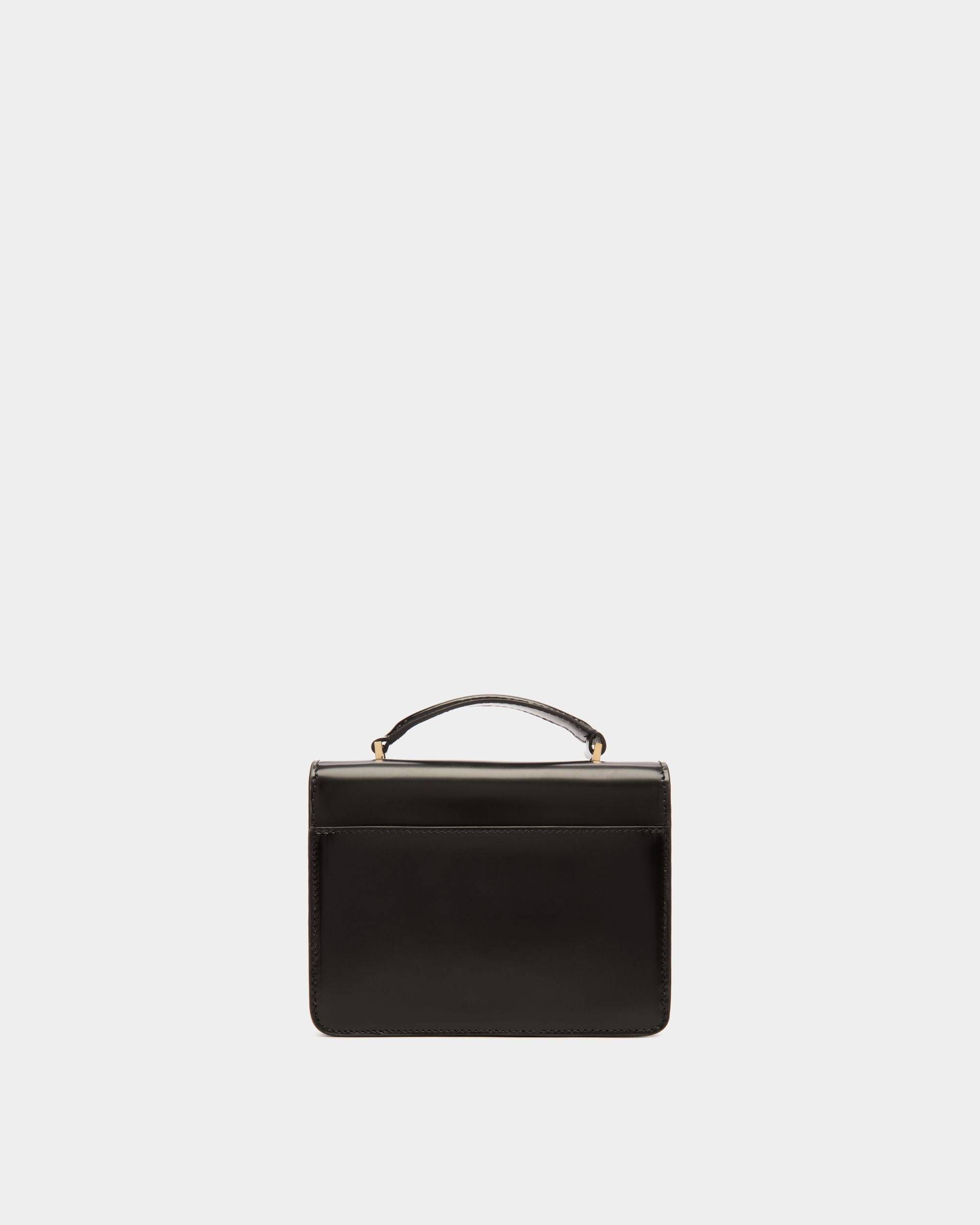 Ollam | Women's Mini Top Handle Bag in Black Brushed Leather | Bally | Still Life Back