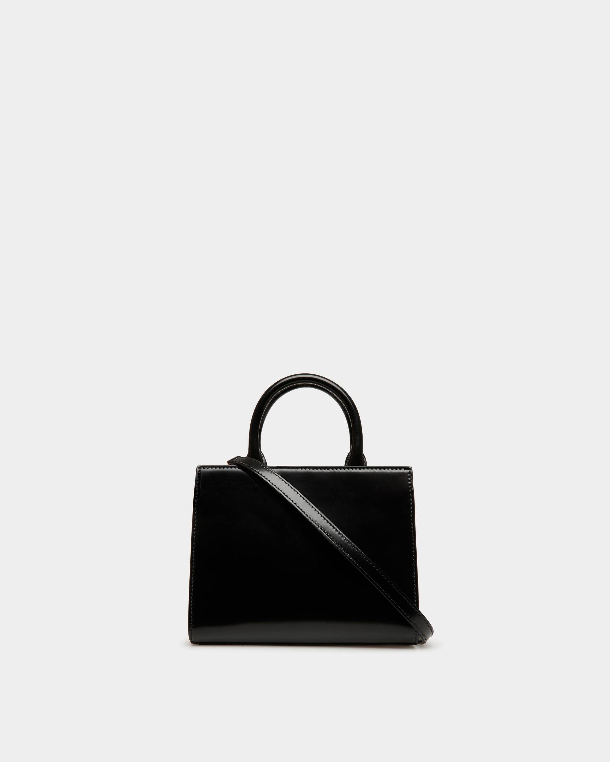 Emblem | Women's Small Tote Bag in Black Brushed Leather | Bally | Still Life Back
