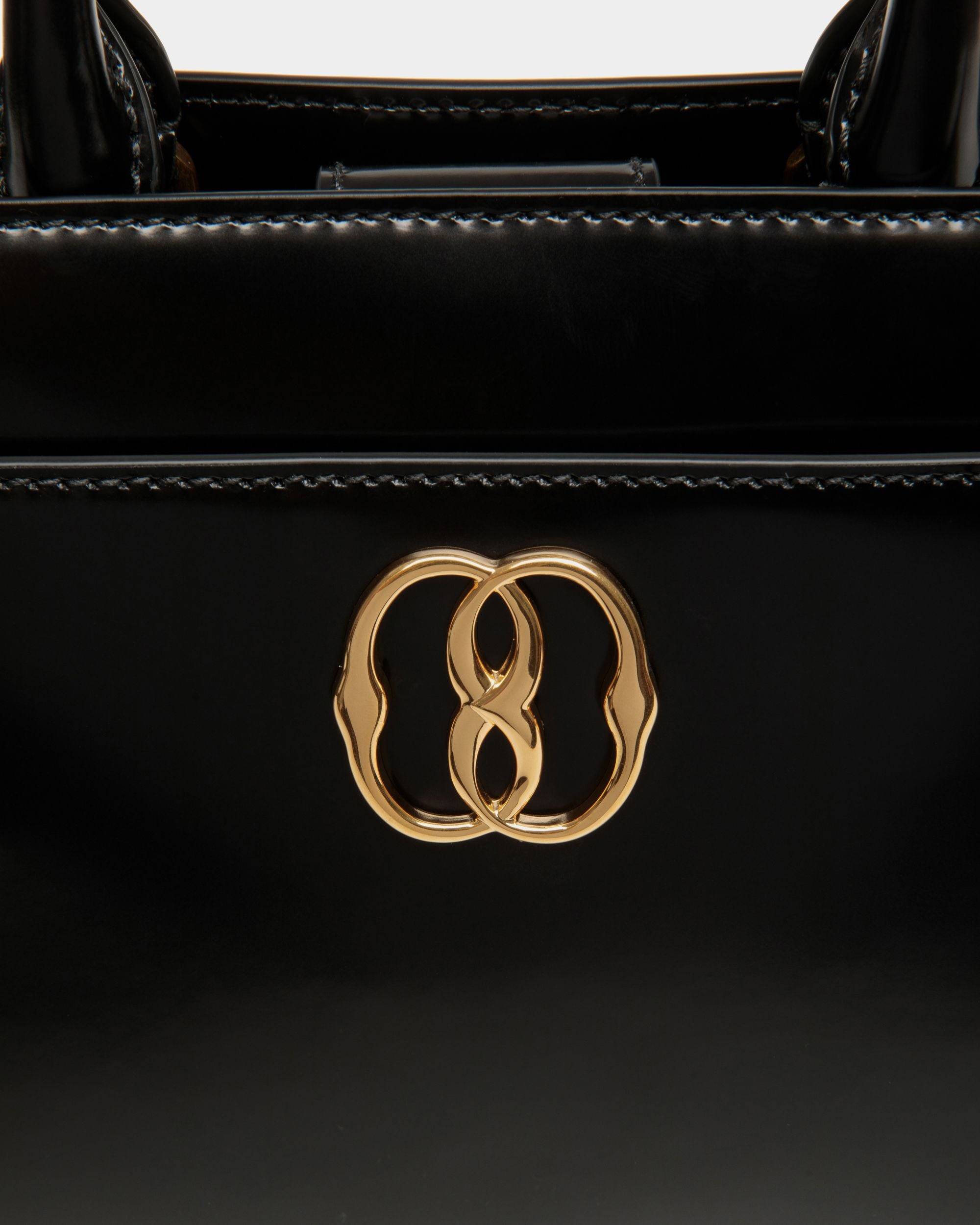 Emblem | Women's Small Tote Bag in Black Brushed Leather | Bally | Still Life Detail