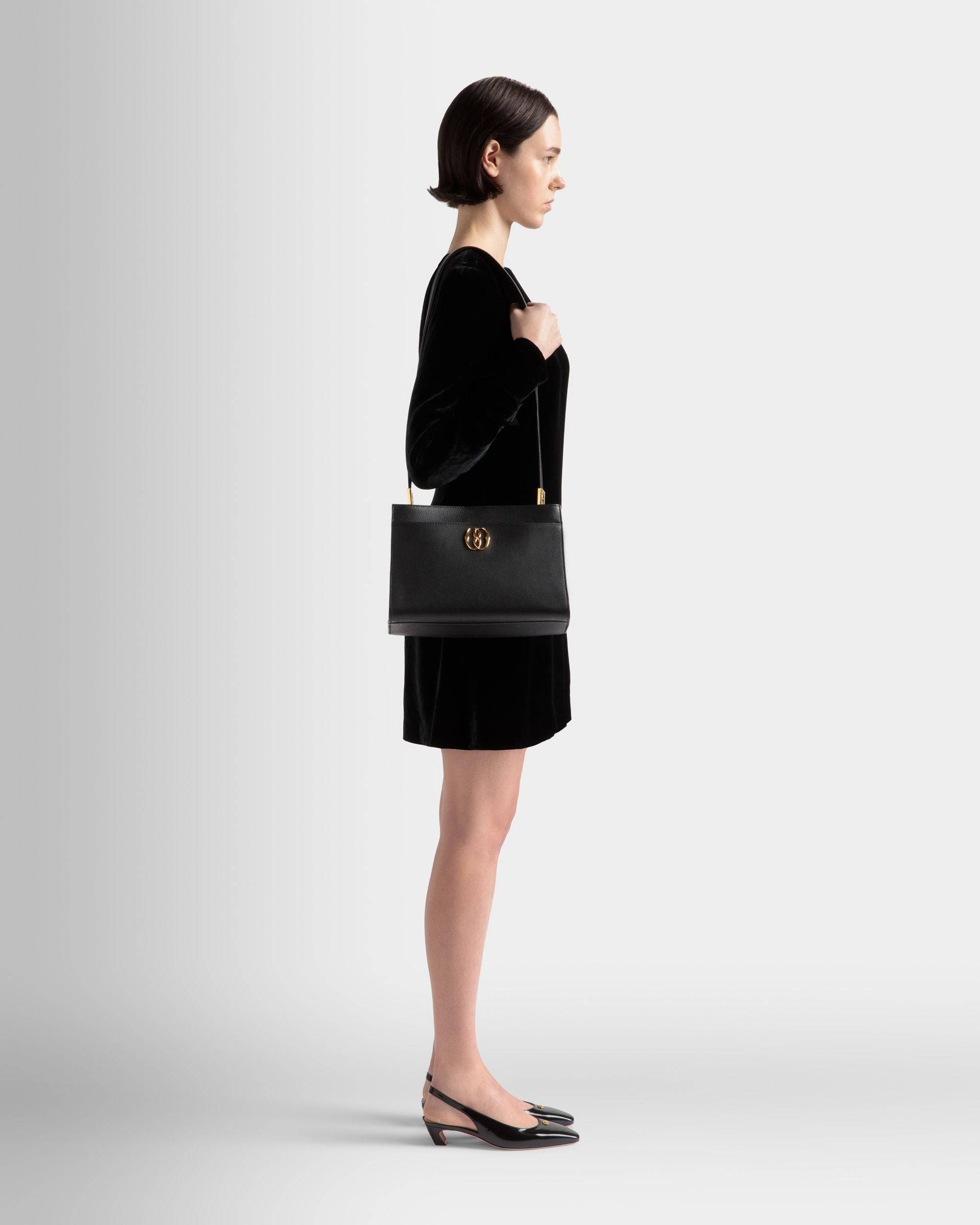 Emblem | Women's Shoulder Bag in Black Grained Leather | Bally | On Model Front