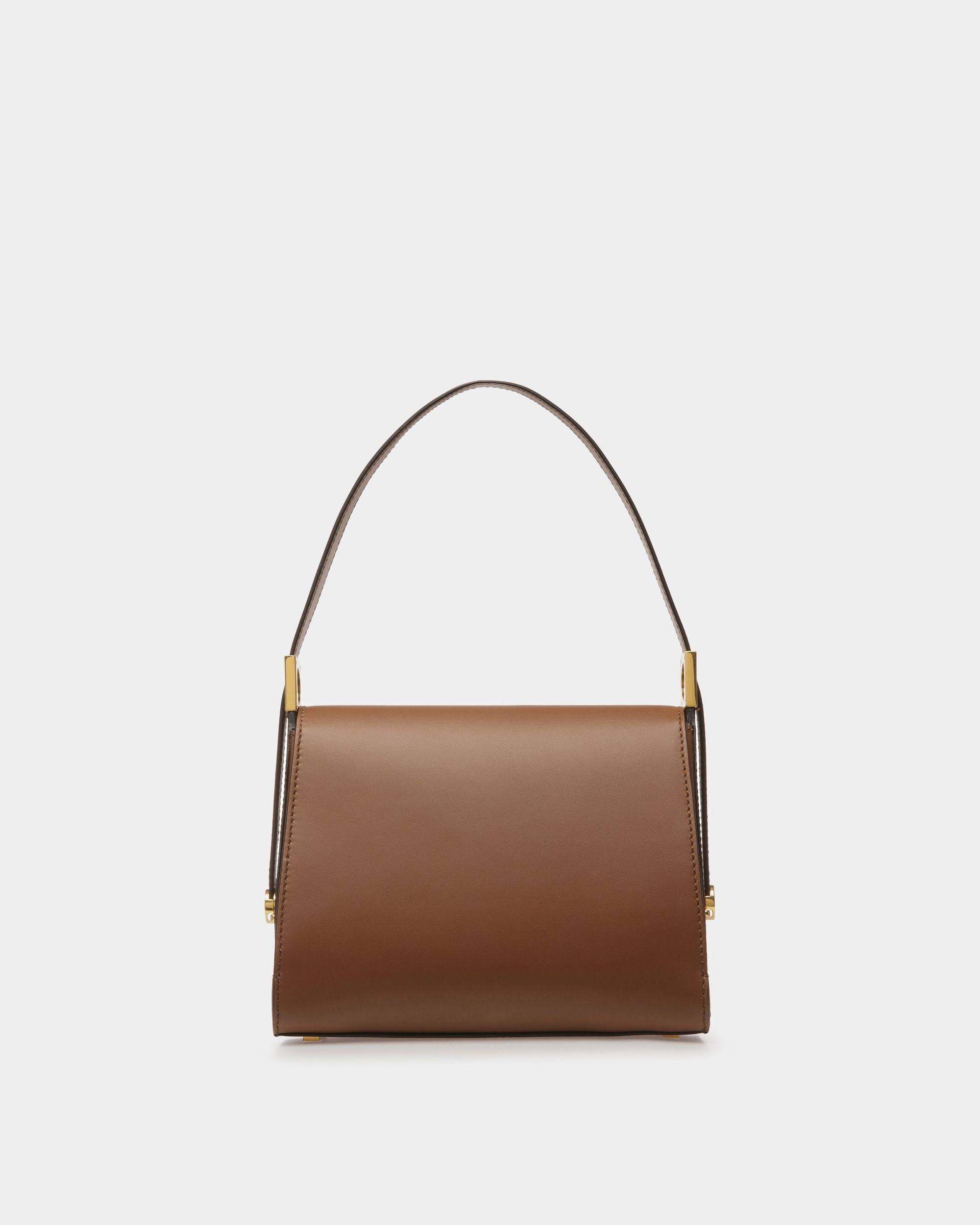 Emblem Trapeze | Women's Top Handle Purse | Brown Leather | Bally | Still Life Back