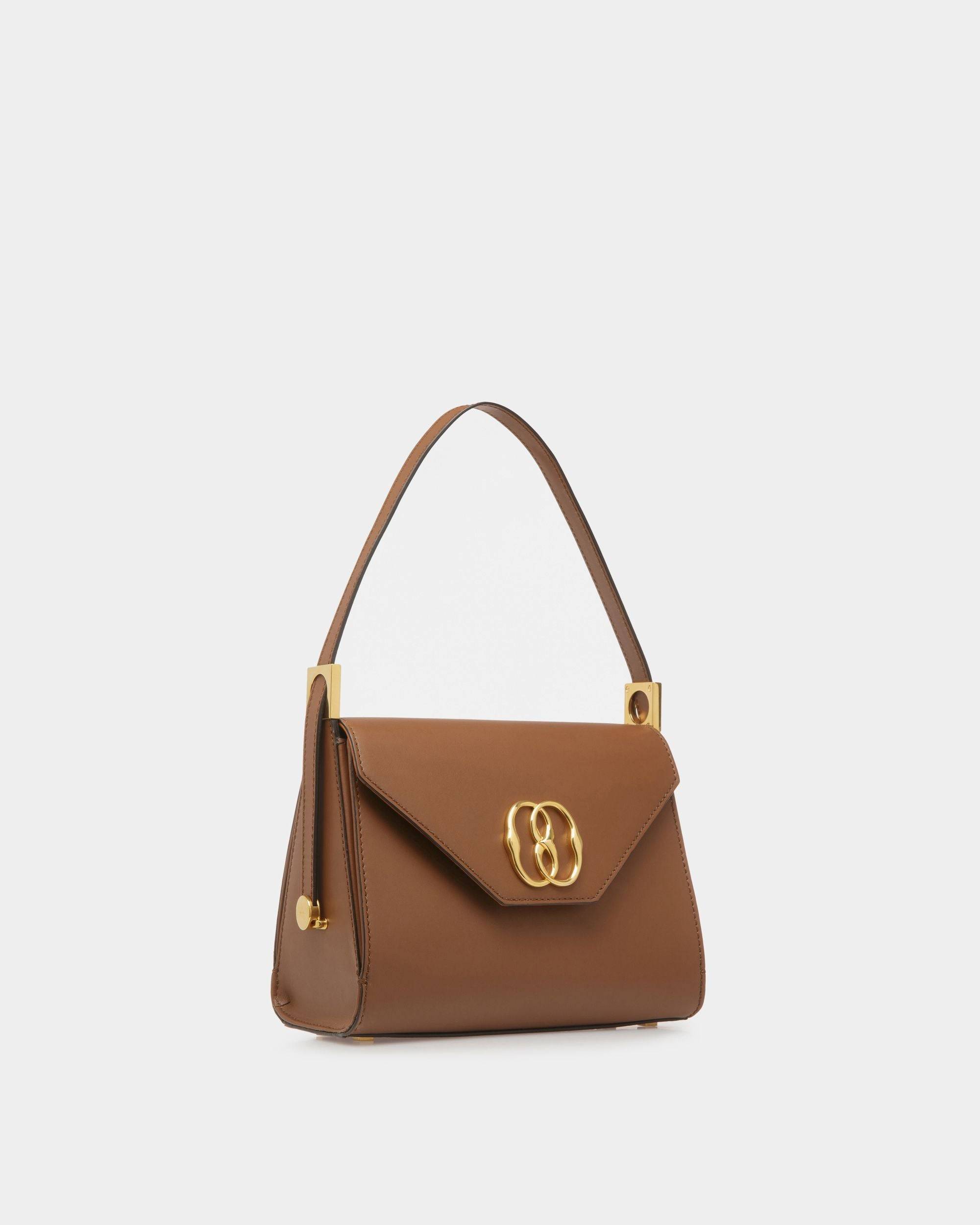 Emblem Trapeze | Women's Top Handle Purse | Brown Leather | Bally | Still Life 3/4 Front