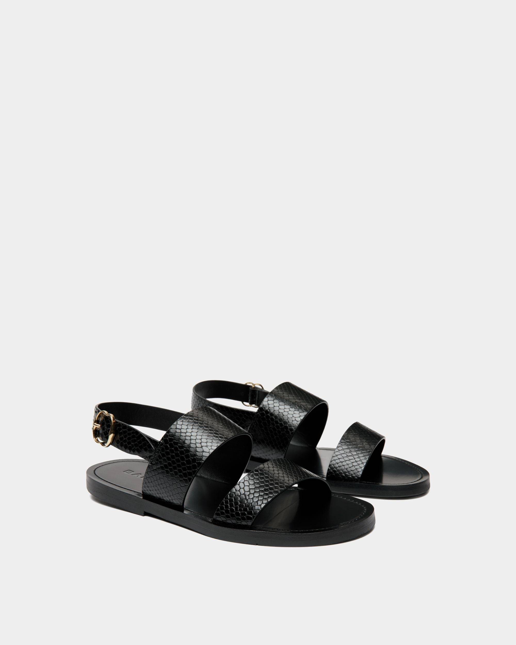 Baudy | Women's Flat Sandal in Black Python Printed Leather | Bally | Still Life 3/4 Front